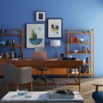 brown wooden desk with rolling chair and shelves near window